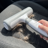 Pawfect Touch Reusable Hair Remover — in use lifting fur from a car seat